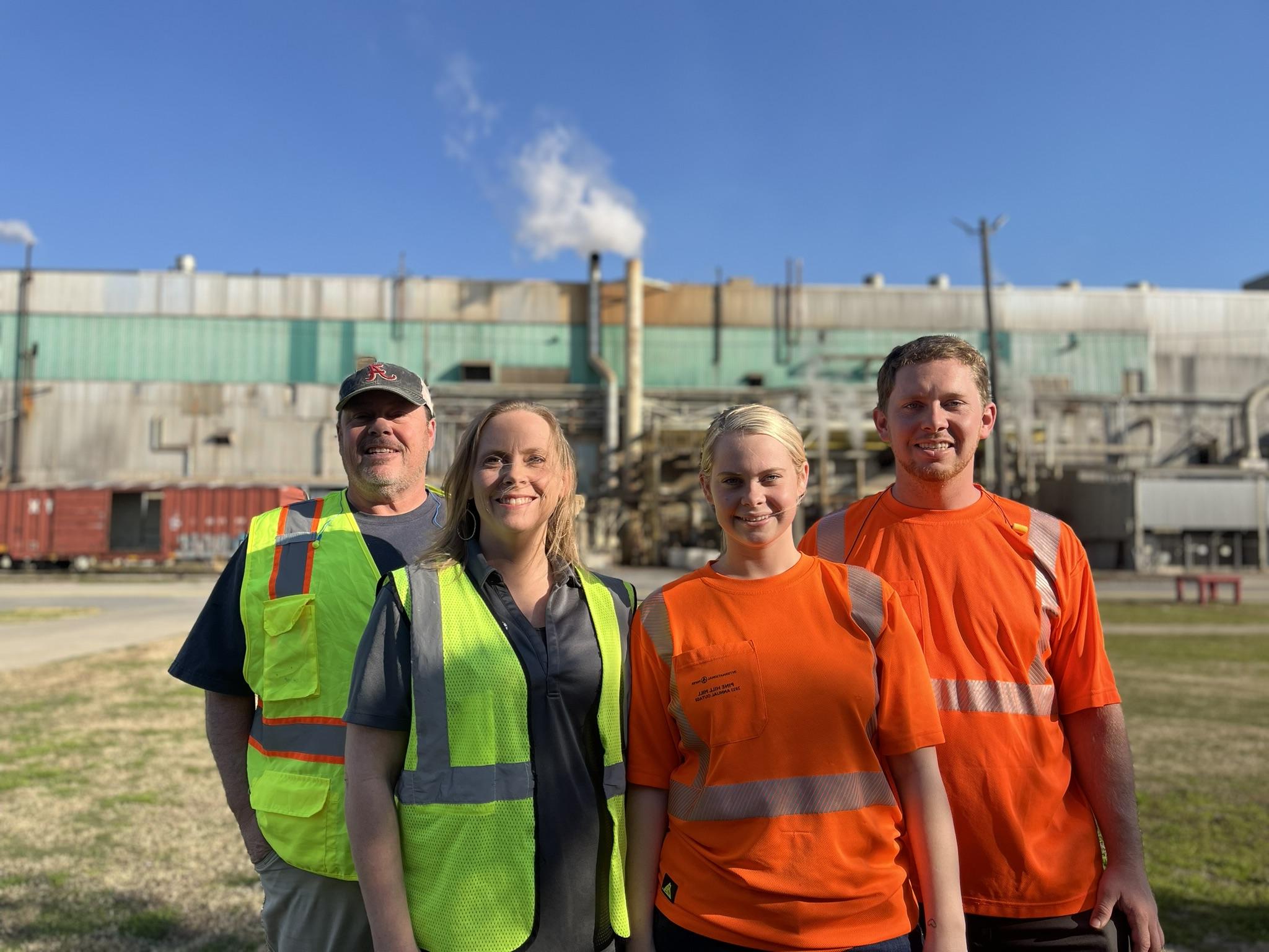 Boyette family members standing in front of IP facility